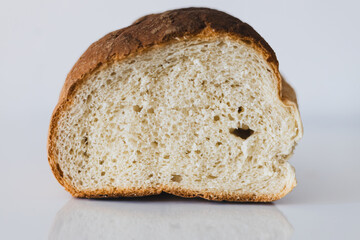 Freshly baked loaf of bread on a clean surface highlighting its texture and inviting appearance