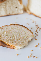 Freshly sliced whole grain bread with scattered seeds on a clean surface captures the essence of wholesome dining and baking during morning hours
