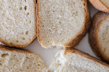 Freshly sliced bread showcases its soft interior and golden crust in a close-up view during a baking session in a cozy kitchen