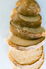 Freshly sliced loaf of bread on a white surface ready for serving at a brunch gathering or family...