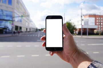Man holding smartphone with white screen in city street