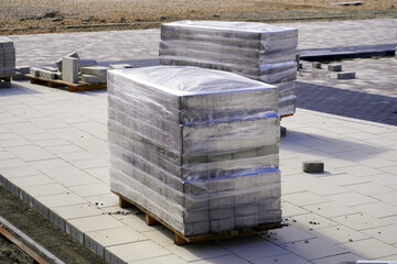 Stacks of paving stone wrapped in plastic on construction site