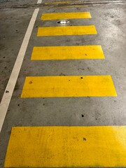 Fototapeta premium close-up of yellow pedestrian crossings in a parking lot 