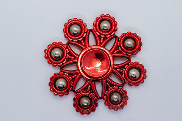 Premium Red Alloy Fidget Spinner with Multiple Bearings on Clean White Base.