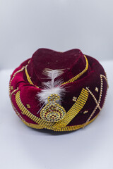 Royal Red and Golden Turban with Embellished Jewel and Elegant Design.
