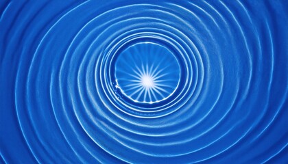 Obraz premium radiant white starburst glowing inside concentric circular blue water ripples abstract pattern for background or texture