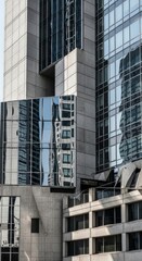 A detailed architectural perspective of a modern skyscraper facade, showcasing intricate concrete panels and reflective glass windows, revealing reflections of other buildings.