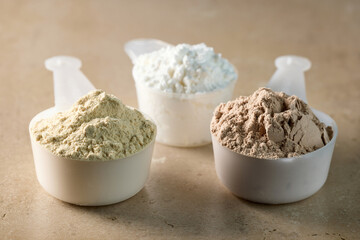 protein powder in scoops. dry mixture for preparation of sporting or dietary drink.