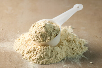 protein powder in scoop. dry mixture for preparation of sporting or dietary drink.