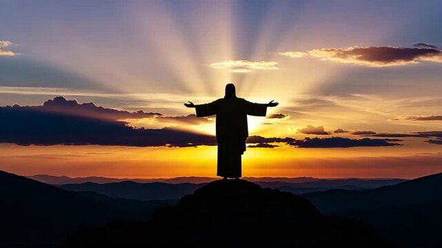 Christ statue with outstretched arms silhouetted against sunset  