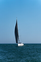 Isolated sailboat on the coast of Algarve, Portugal