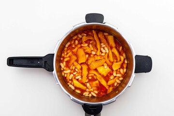 A classic Brazilian dish known as dobradinha, prepared with beef tripe, white beans, and tropical...