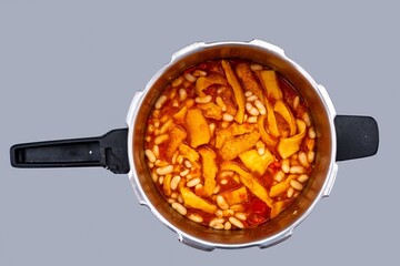 A classic Brazilian dish known as dobradinha, prepared with beef tripe, white beans, and tropical spices, served with traditional farofa made from toasted cassava flour.