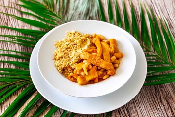 A classic Brazilian dish known as dobradinha, prepared with beef tripe, white beans, and tropical...