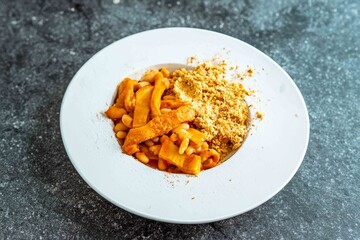 A classic Brazilian dish known as dobradinha, prepared with beef tripe, white beans, and tropical...