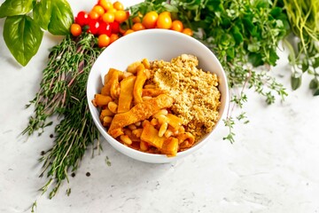 A classic Brazilian dish known as dobradinha, prepared with beef tripe, white beans, and tropical spices, served with traditional farofa made from toasted cassava flour.
