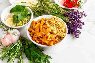 A classic Brazilian dish known as dobradinha, prepared with beef tripe, white beans, and tropical spices, served with traditional farofa made from toasted cassava flour.