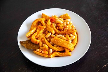 A classic Brazilian dish known as dobradinha, prepared with beef tripe, white beans, and tropical...