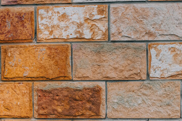 Orange brick wall texture with natural patterns and rough surface.