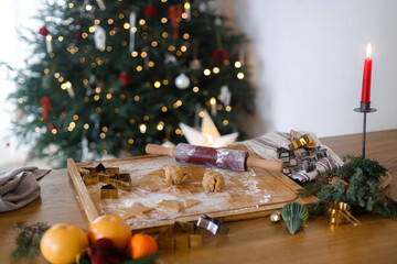 Making gingerbread christmas cookies. Wooden board, gingerbread dough, rolling pin and metal...