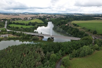 Large suspended bridge and main road over Jordan reservoir in Tabor aerial view