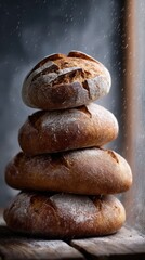Rustic artisanal boules stack on wooden surface