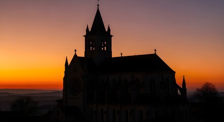 Obraz premium Majestic church silhouette against a vibrant sunset sky, evoking peace and contemplation