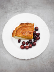 Slice of pumpkin pie with cranberries on white plate for thanksgiving dinner