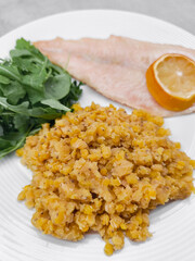 Steamed fish fillet with red lentils and arugula salad for healthy meal