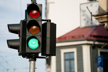 Traffic light with green signal illuminated on Riga street, symbolizing urban mobility, safe crossing, transportation system and daily flow of city life with order and rules