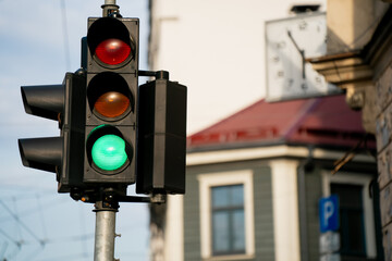 Green traffic light at street crossing, symbol of go and movement in daily city transport, urban travel, pedestrian lifestyle, cars, road safety, stop and go in public life