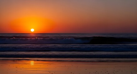 Fototapeta premium Stunning ocean sunset paints sky with vibrant orange hues, waves gently roll onto shore