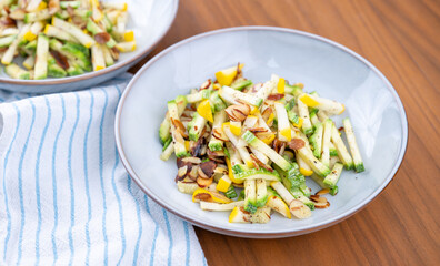 Close up of Simple Vegetarian Side with Green and Yellow Zucchini and Toasted Almonds