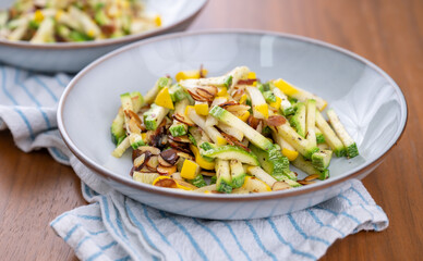 Close up of Simple Vegetarian Side with Green and Yellow Zucchini and Toasted Almonds