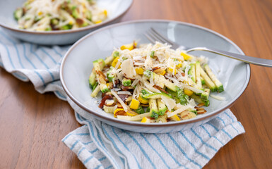 Close up of Simple Vegetarian Side with Green and Yellow Zucchini and Toasted Almonds