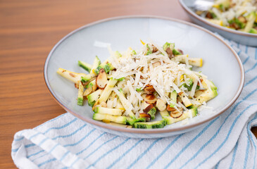 Close up of Simple Vegetarian Side with Green and Yellow Zucchini and Toasted Almonds