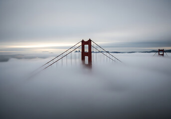 Obraz premium Golden gate bridge tower emerges from thick fog in san francisco