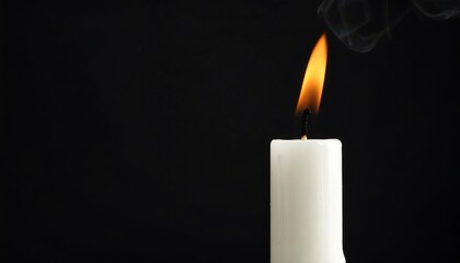 Single white candle flame on black background