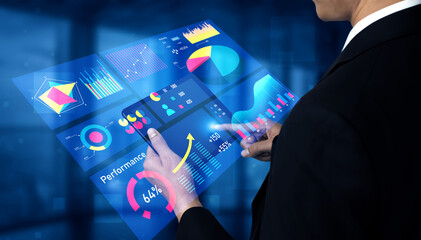 A businessman interacts with innovative digital data visualizations in a modern office, exploring interactive charts and performance metrics for informed decisions. Impute