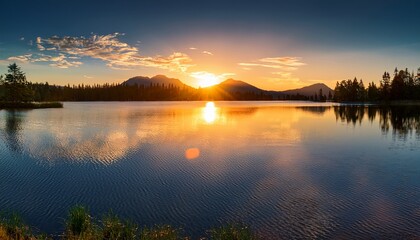 Fototapeta premium calm sunset reflections on tranquil lake creating warm atmosphere