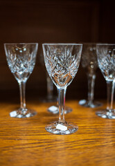 Crystal wine glasses displayed on wooden surface.