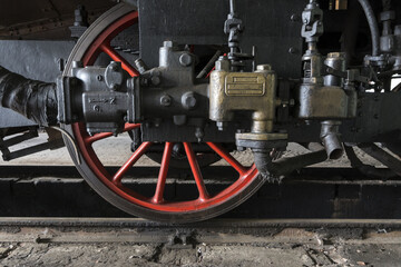 red gears of an old steam locomotive