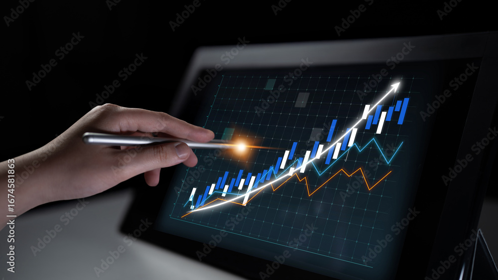 Poster a hand holds a stylus, interacting with a digital screen displaying dynamic financial graphs and col