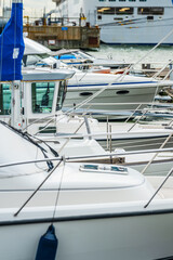 Fototapeta premium Closeup view of several docked white boats.