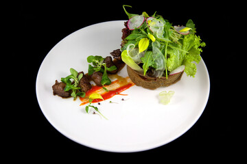Beautiful haute cuisine restaurant dish. Fried pieces of meat with sauce, fresh herbs and crispy...