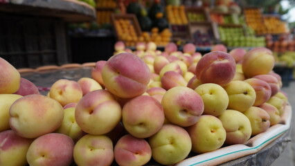 Close up of shiny yellow red fruit pile, blurred background