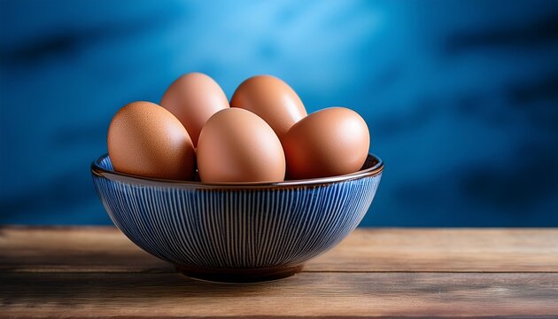 eggs in patterned bowl on wooden surface with blue background natural light creating calm and fresh atmosphere