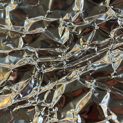 Aluminum Foil Texture: A macro view reveals a mesmerizing texture of crumpled foil, where light dances on its textured surface, showcasing abstract shapes and metallic gleam.