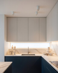 Minimalist Kitchen Navy and Cream with Marble Countertops Subtle Lighting Vertical