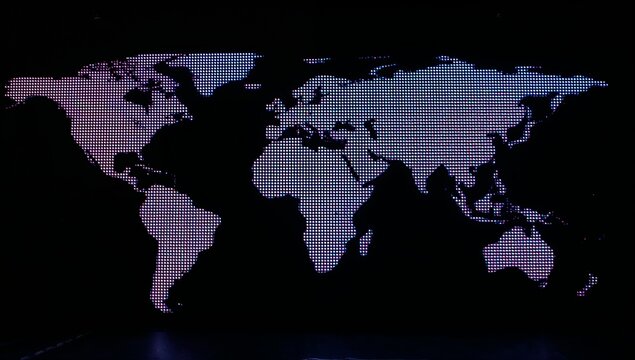 Displaying dotted world map on LED display screen at dark stage, with gradient lights